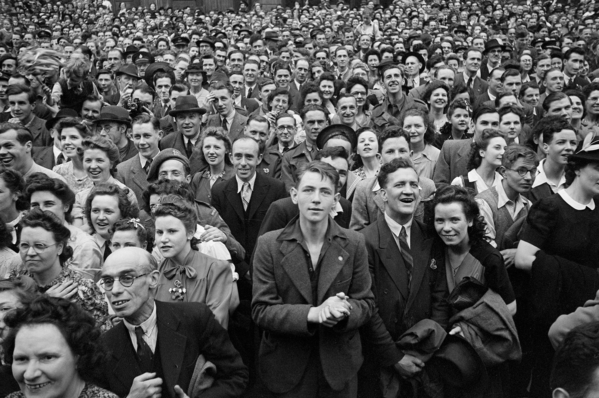 A crowd of people celebrating VE day
